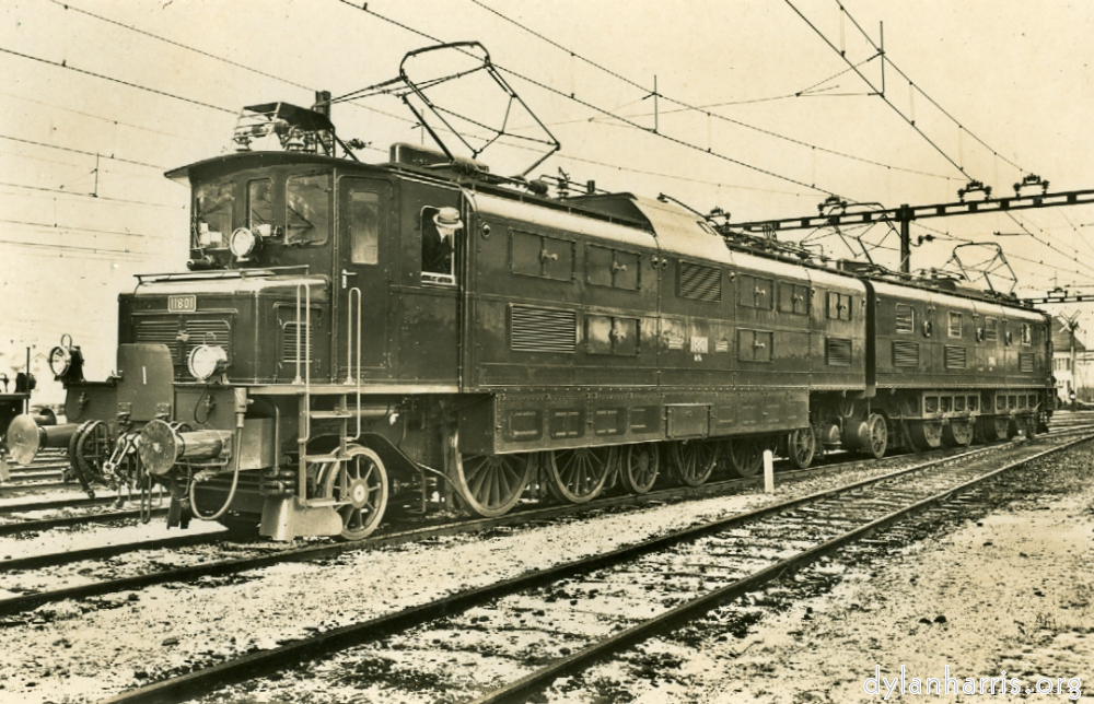 image: Postcard: 11801 [[ St. Gotthard Line Goods Locomotive. 15kv 8,500HP. Length 111.5ft. Service Weight 244 metric tons. Maximum Speed 62mph. Load of 750 metric tons hauled up gradient of 27% at 30mph. ]]
